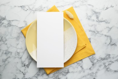 Empty menu, plate, napkin and dry spike on white marble table, top view. Mockup for design