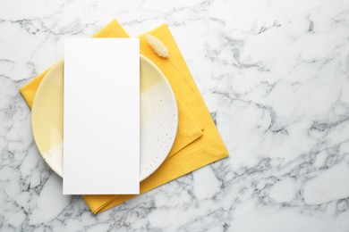 Photo of Empty menu, plate, napkin and dry spike on white marble table, top view. Mockup for design