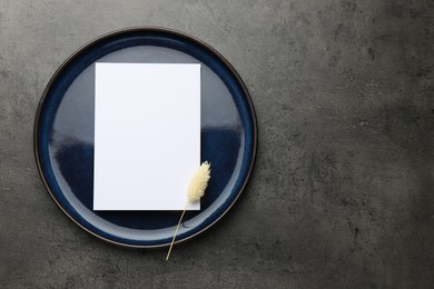 Photo of Empty menu, plate and dry spike on grey table, top view. Mockup for design