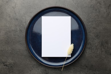 Empty menu, plate and dry spike on grey table, top view. Mockup for design