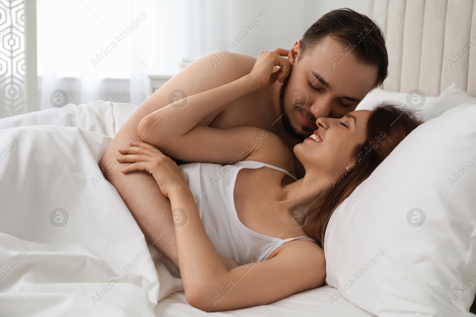 Photo of Lovely couple enjoying time together in bed at morning