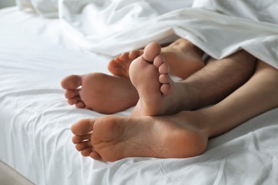 Lovely couple lying in bed at home, closeup view