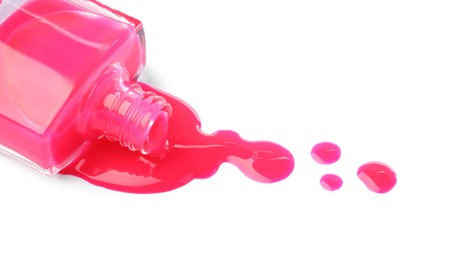 Photo of Bottle and spilled pink nail polish isolated on white