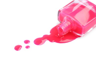 Photo of Bottle and spilled pink nail polish isolated on white