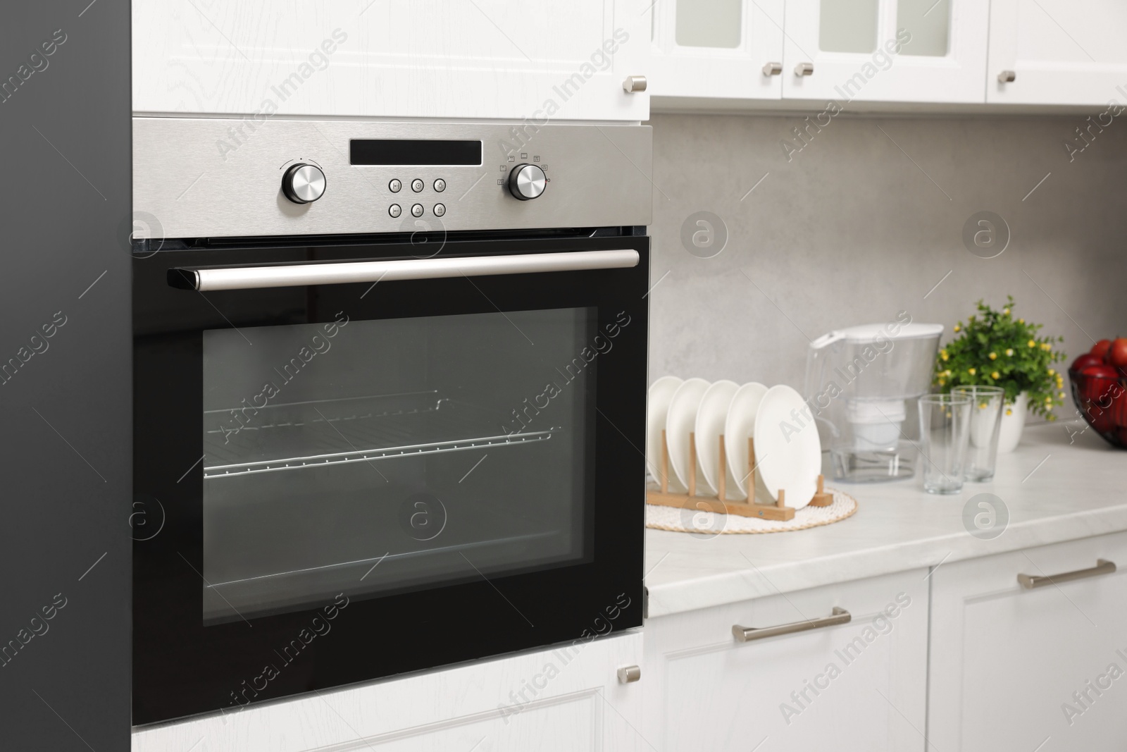 Photo of New electric oven in kitchen. Cooking appliance