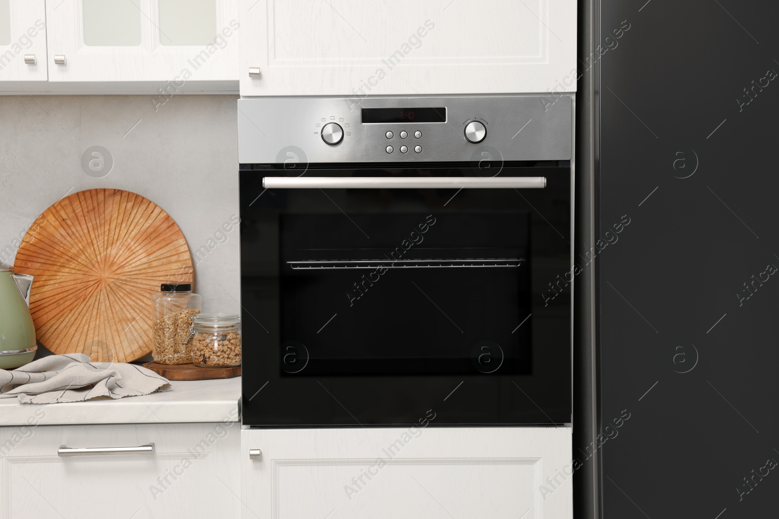 Photo of New electric oven in kitchen. Cooking appliance