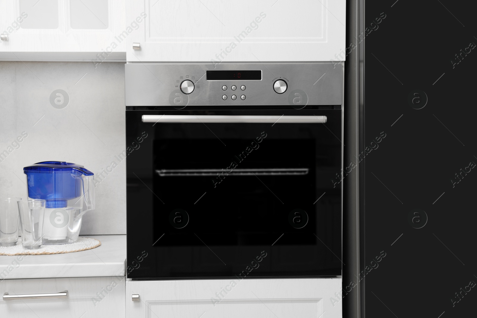 Photo of New electric oven in kitchen. Cooking appliance