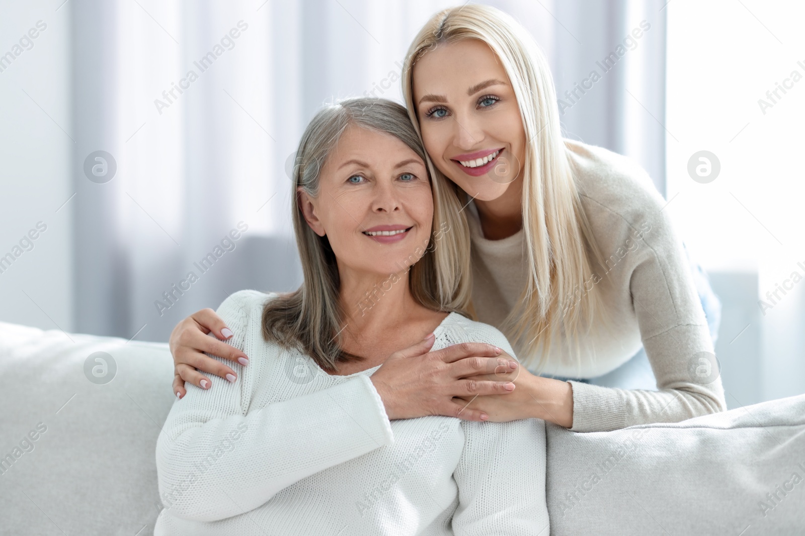 Photo of Family portrait of young woman and her mother at home