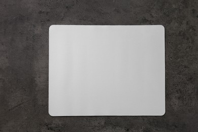 Photo of One mouse pad on black textured table, top view. Space for text