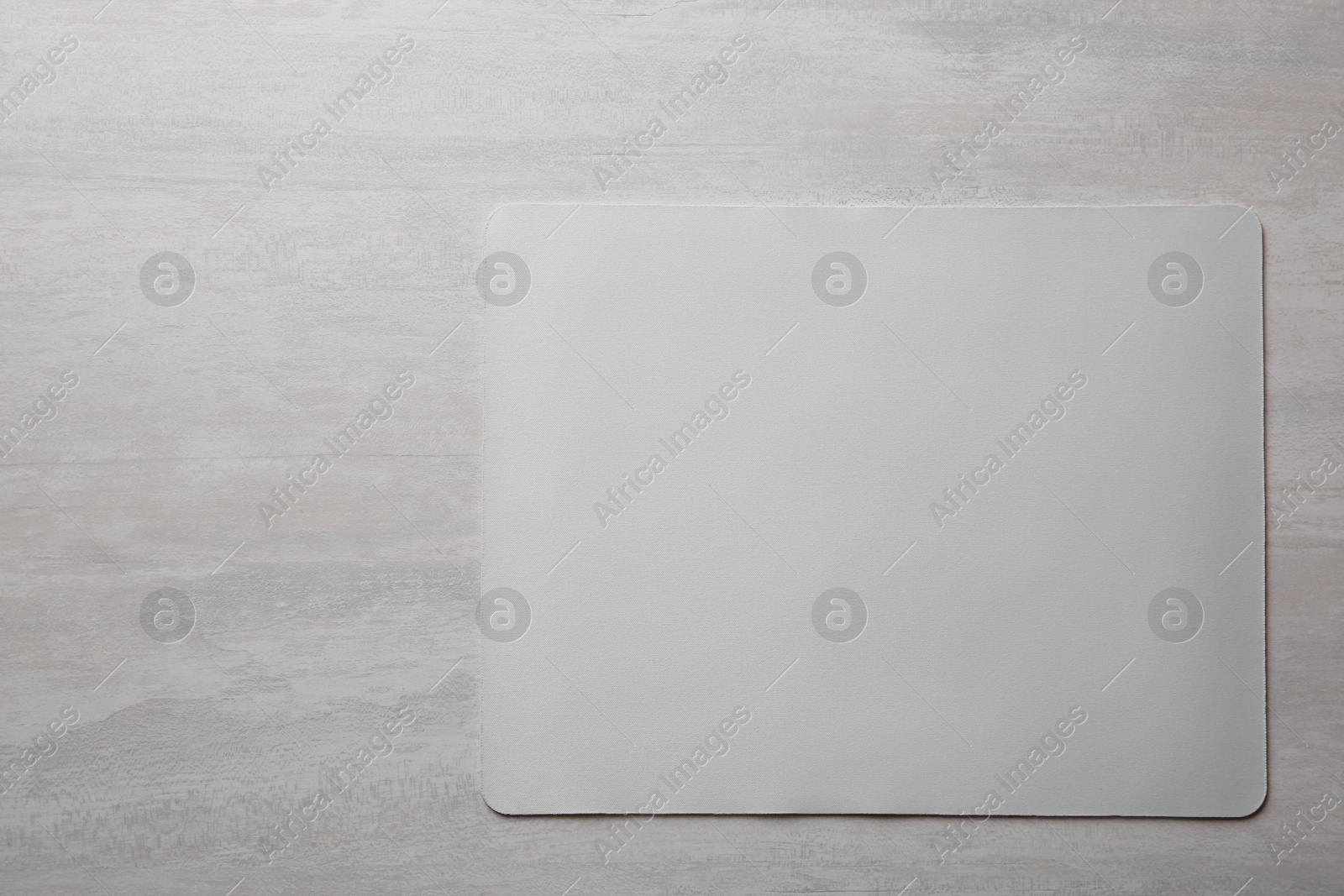 Photo of One mouse pad on grey wooden table, top view. Space for text