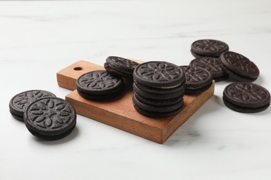 Photo of Tasty sandwich cookies on white table, closeup