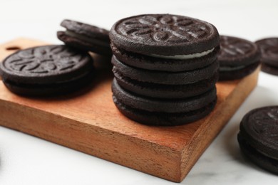 Photo of Tasty sandwich cookies on white table, closeup