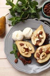 Photo of Delicious baked pears with nuts, ice cream, mint, anise and honey on light wooden table, flat lay