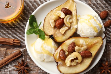 Photo of Delicious baked pears with nuts, ice cream, anise stars and honey on wooden rustic table, flat lay