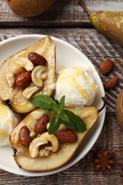 Photo of Delicious baked pears with nuts, ice cream and honey on wooden rustic table, flat lay
