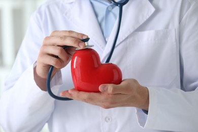 Photo of Doctor with stethoscope and red heart, closeup