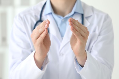 Photo of Doctor holding something in clinic, closeup view