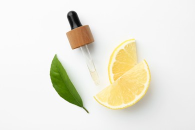 Photo of Pipette of essential oil, lemon and green leaf on white background, flat lay