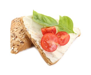 Photo of Pieces of bread with cream cheese, basil leaves and tomato isolated on white