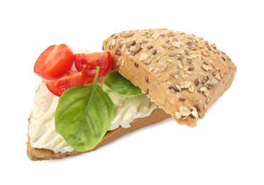 Photo of Pieces of bread with cream cheese, basil leaves and tomato isolated on white