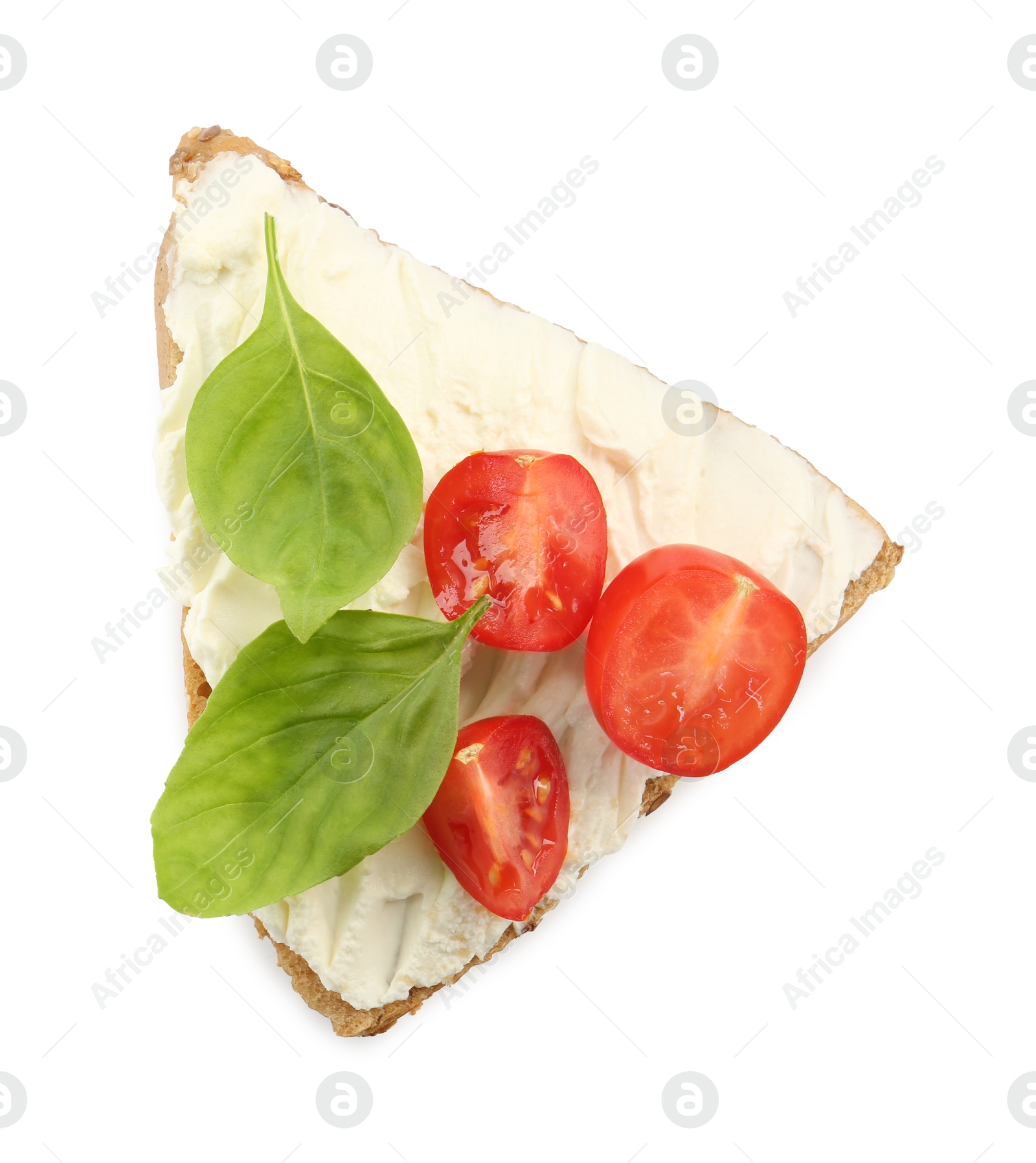 Photo of Piece of bread with cream cheese, basil leaves and tomato isolated on white, top view