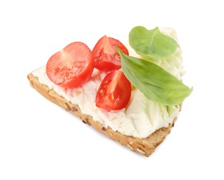 Photo of Piece of bread with cream cheese, basil leaves and tomato isolated on white