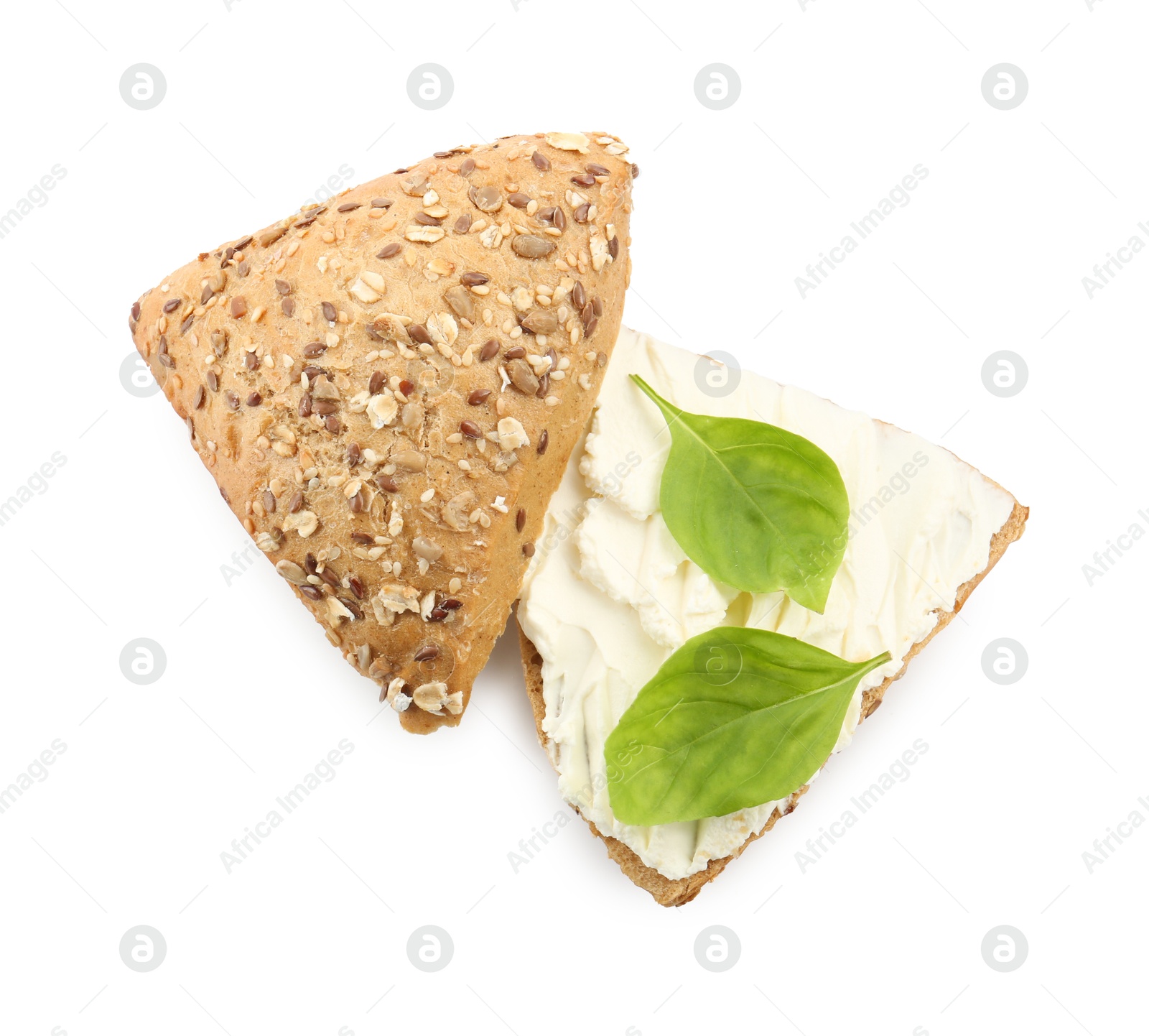 Photo of Pieces of bread with cream cheese and basil leaves isolated on white, top view