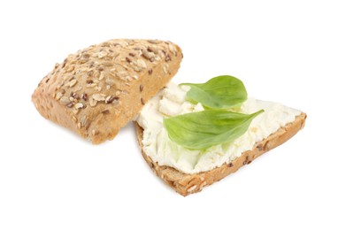 Photo of Pieces of bread with cream cheese and basil leaves isolated on white