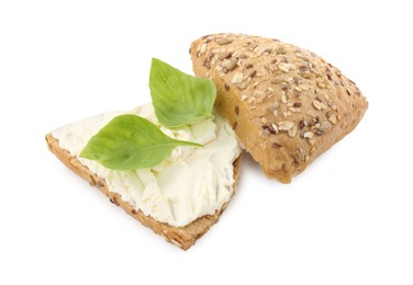 Photo of Pieces of bread with cream cheese and basil leaves isolated on white
