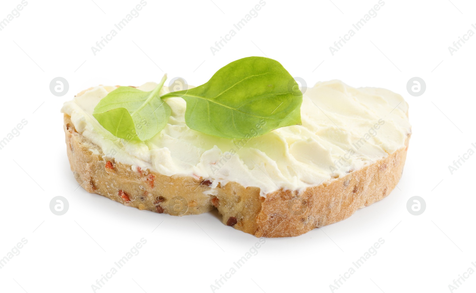 Photo of Piece of bread with cream cheese and basil leaves isolated on white