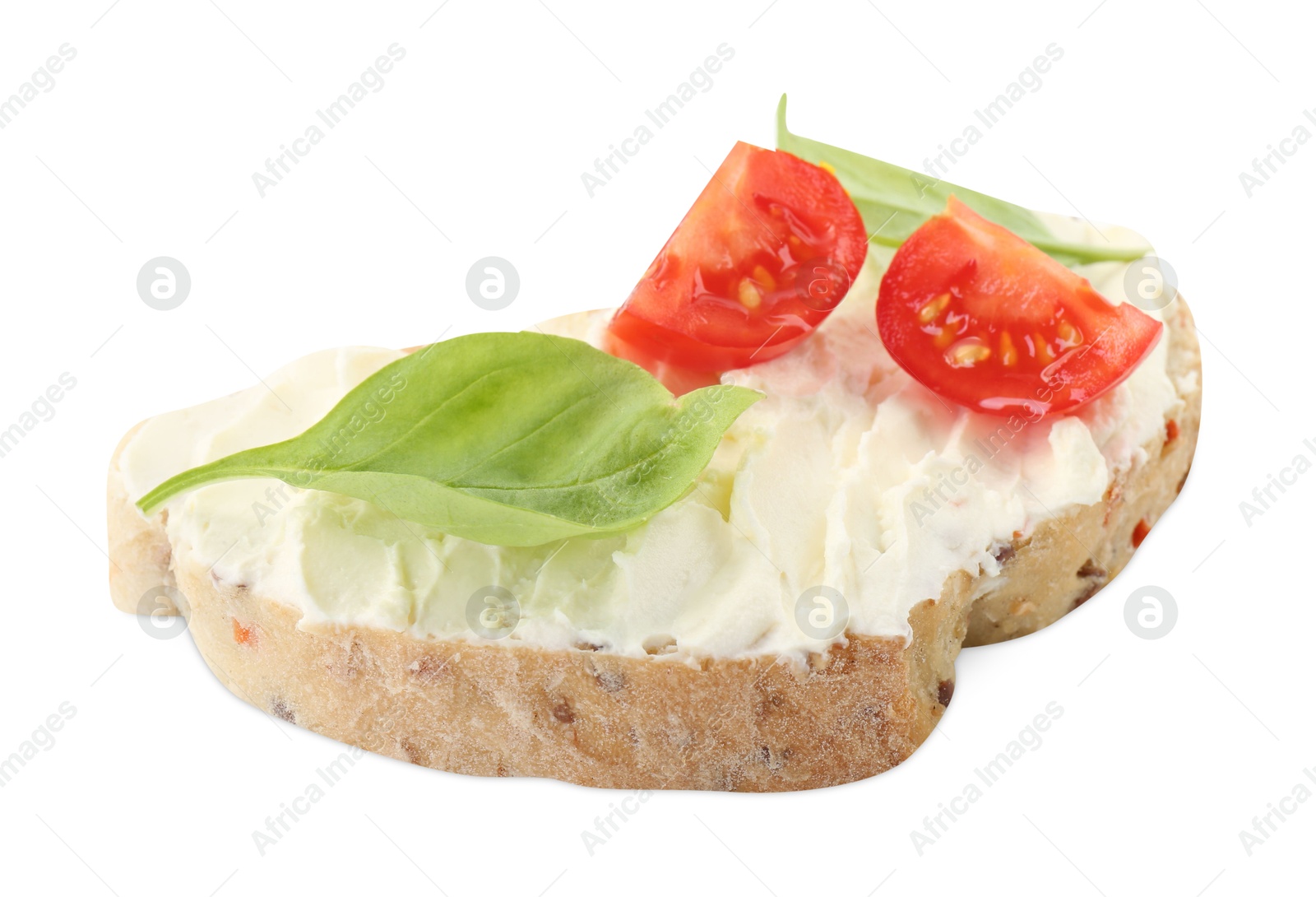 Photo of Piece of bread with cream cheese, basil leaves and tomato isolated on white