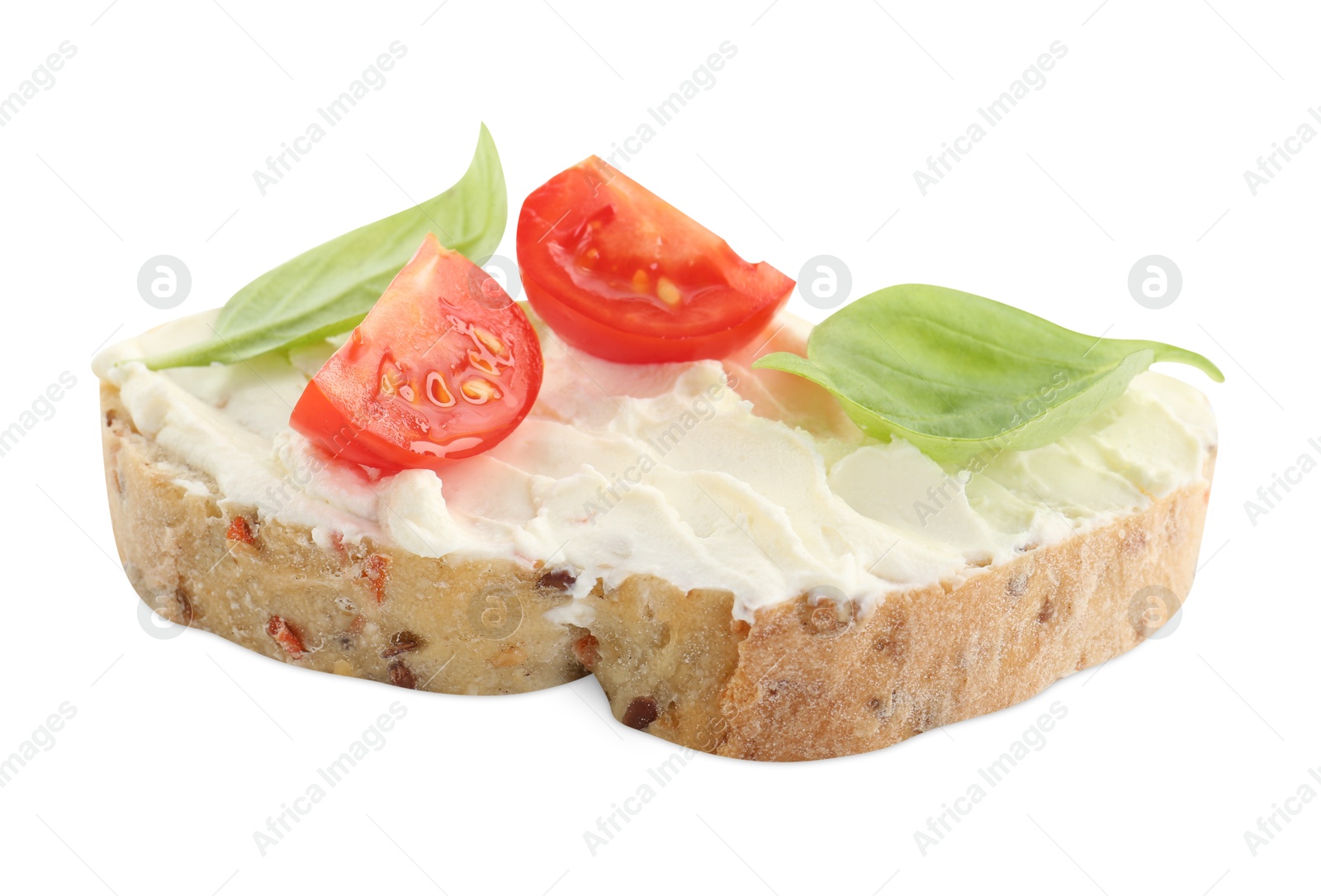 Photo of Piece of bread with cream cheese, basil leaves and tomato isolated on white