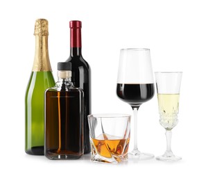 Bottles and glasses with different alcoholic drinks isolated on white