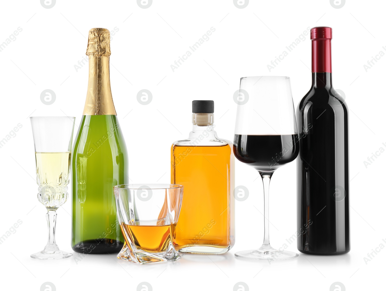 Photo of Bottles and glasses with different alcoholic drinks isolated on white