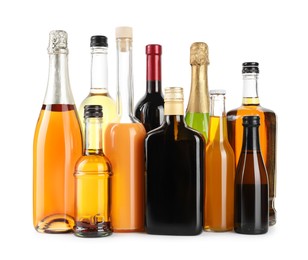 Bottles of different alcoholic drinks isolated on white