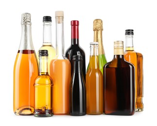 Bottles of different alcoholic drinks isolated on white