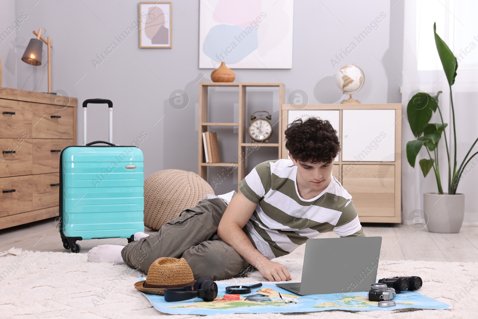 Photo of Travel blogger using laptop for planning trip at home