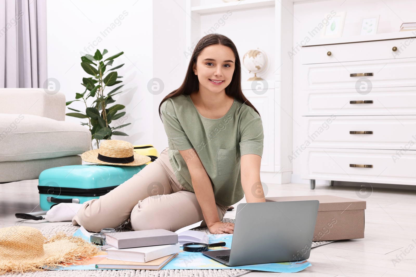 Photo of Travel blogger using laptop for planning trip at home