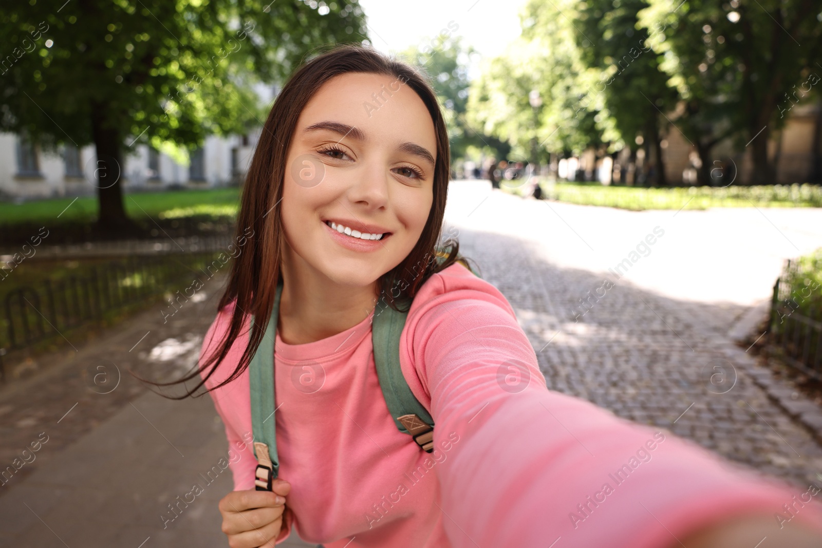 Photo of Beautiful young travel blogger takIng selfie outdoors