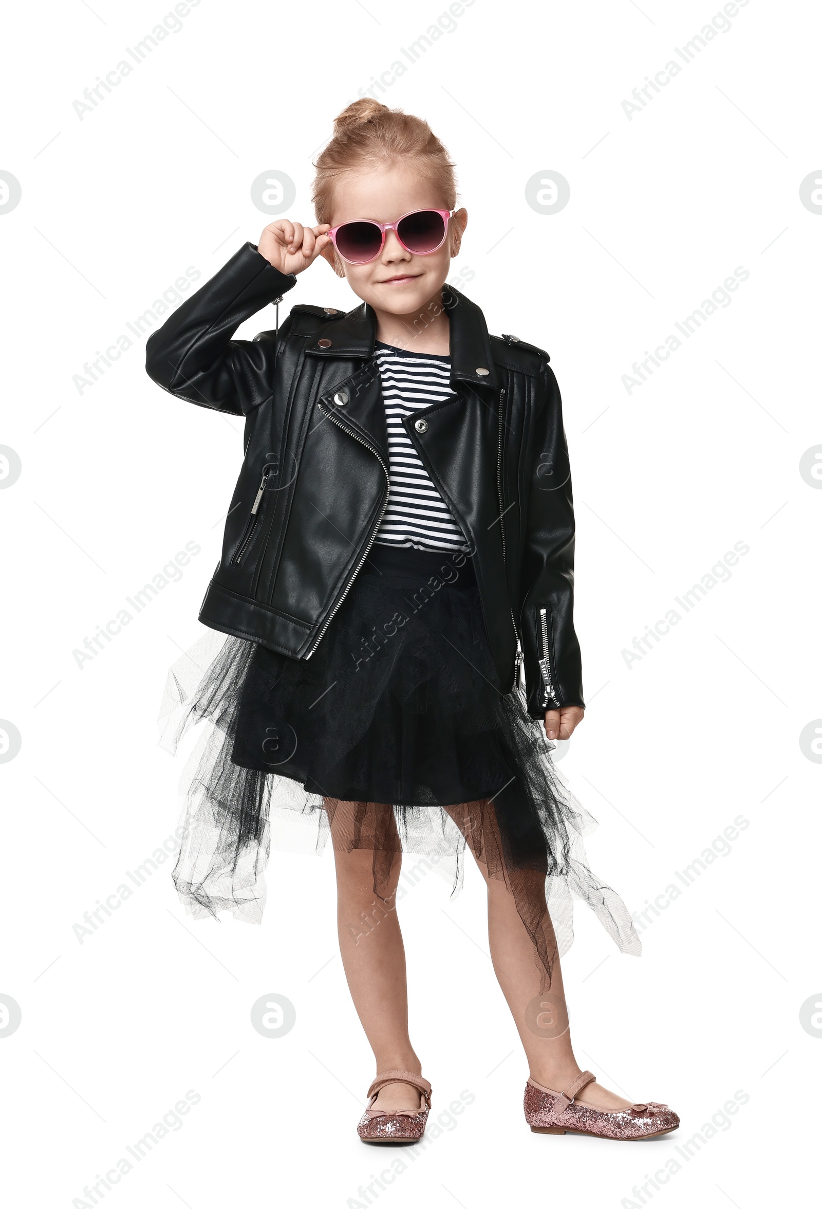 Photo of Cute little girl in sunglasses dancing on white background
