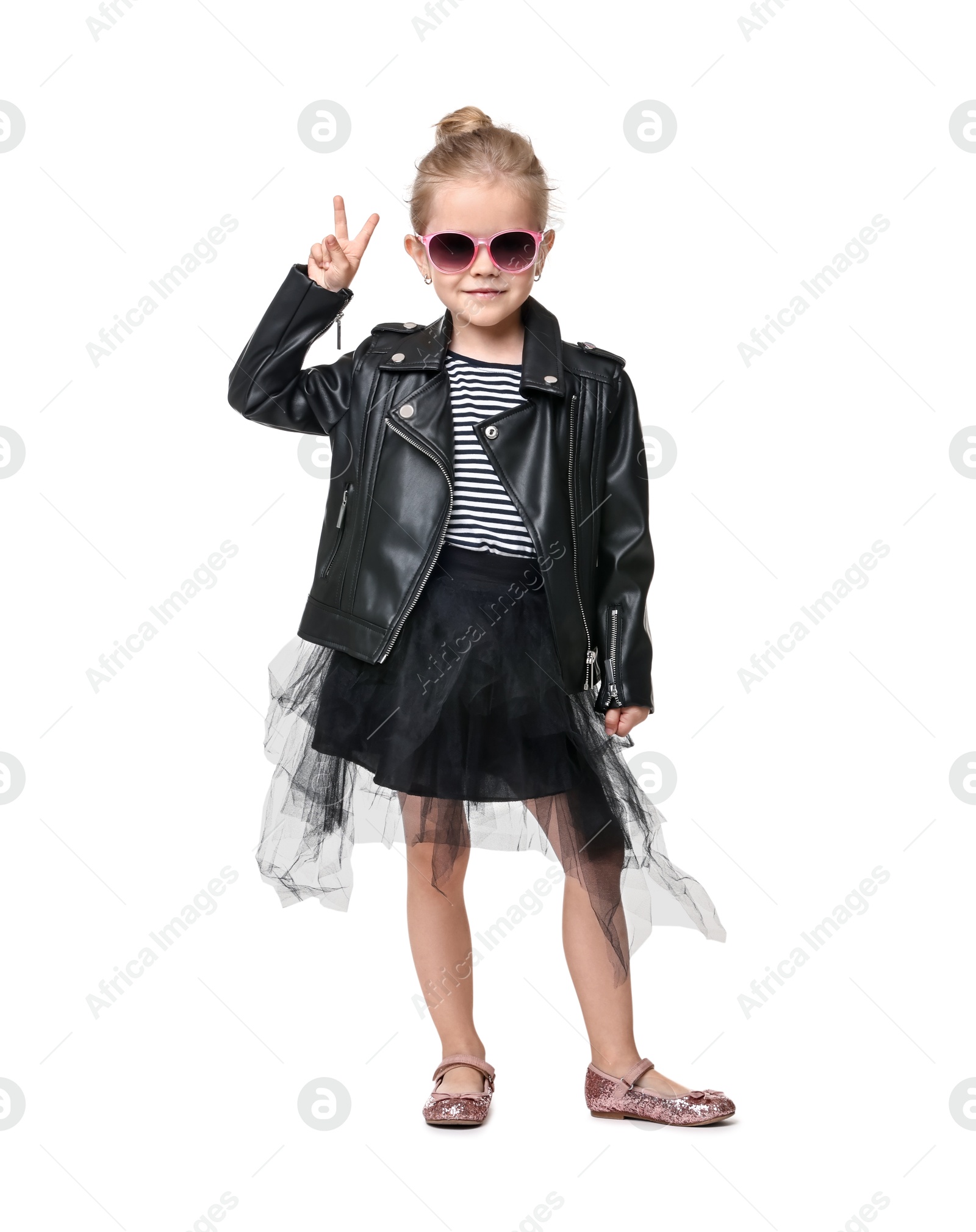 Photo of Cute little girl in sunglasses dancing and showing peace sign on white background