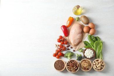 Many different healthy food on white wooden table, flat lay. Space for text