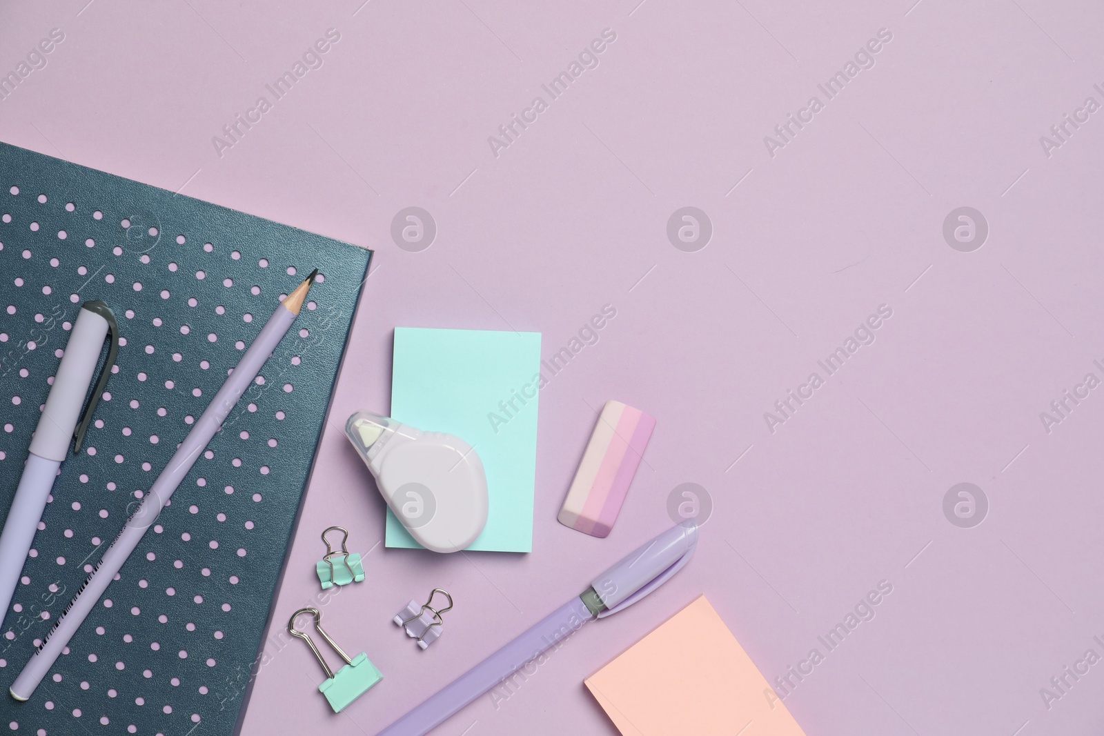 Photo of Flat lay composition with notebook and different stationery on violet background