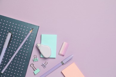 Photo of Flat lay composition with notebook and different stationery on violet background