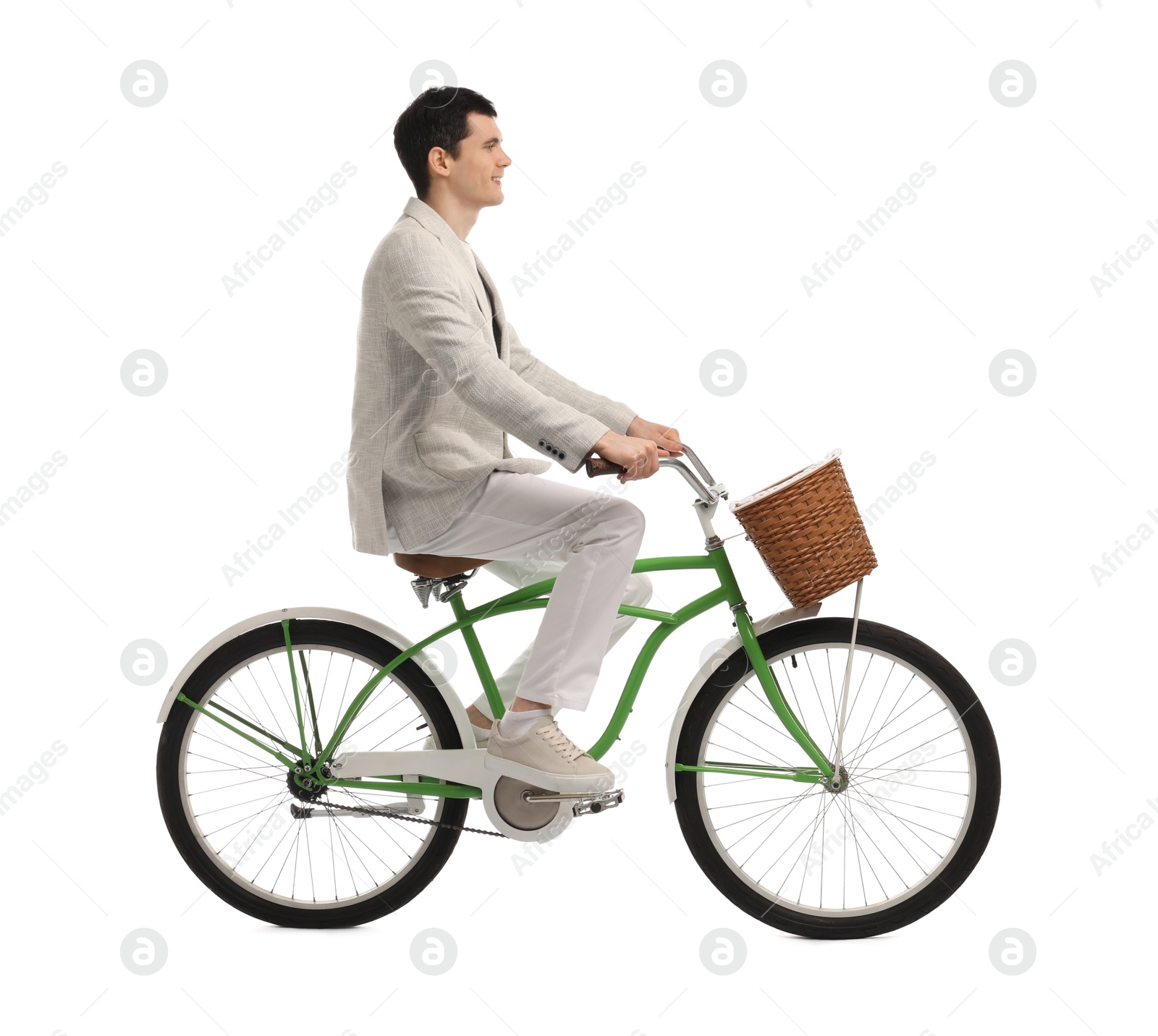 Photo of Smiling man riding bicycle with basket on white background