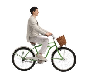 Smiling man riding bicycle with basket on white background