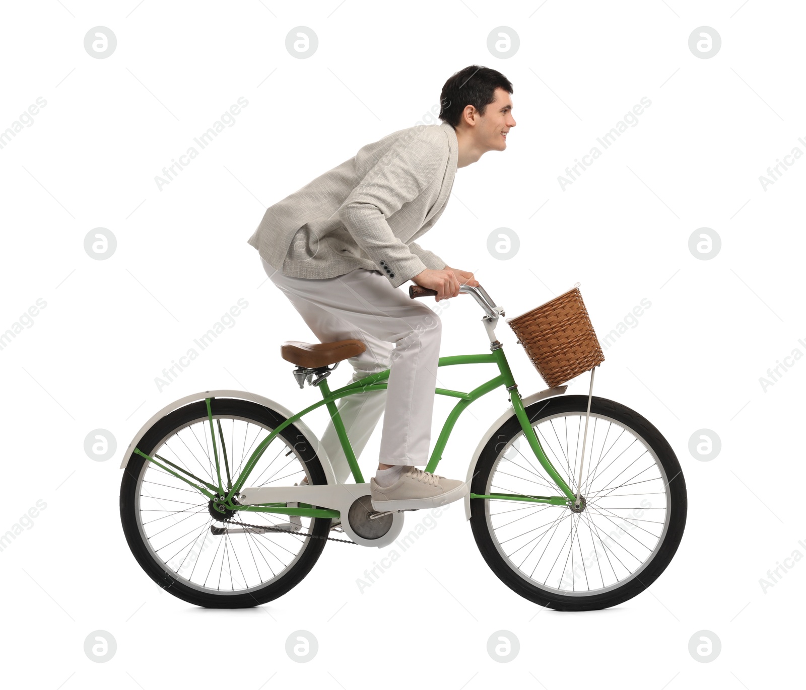 Photo of Smiling man riding bicycle with basket on white background