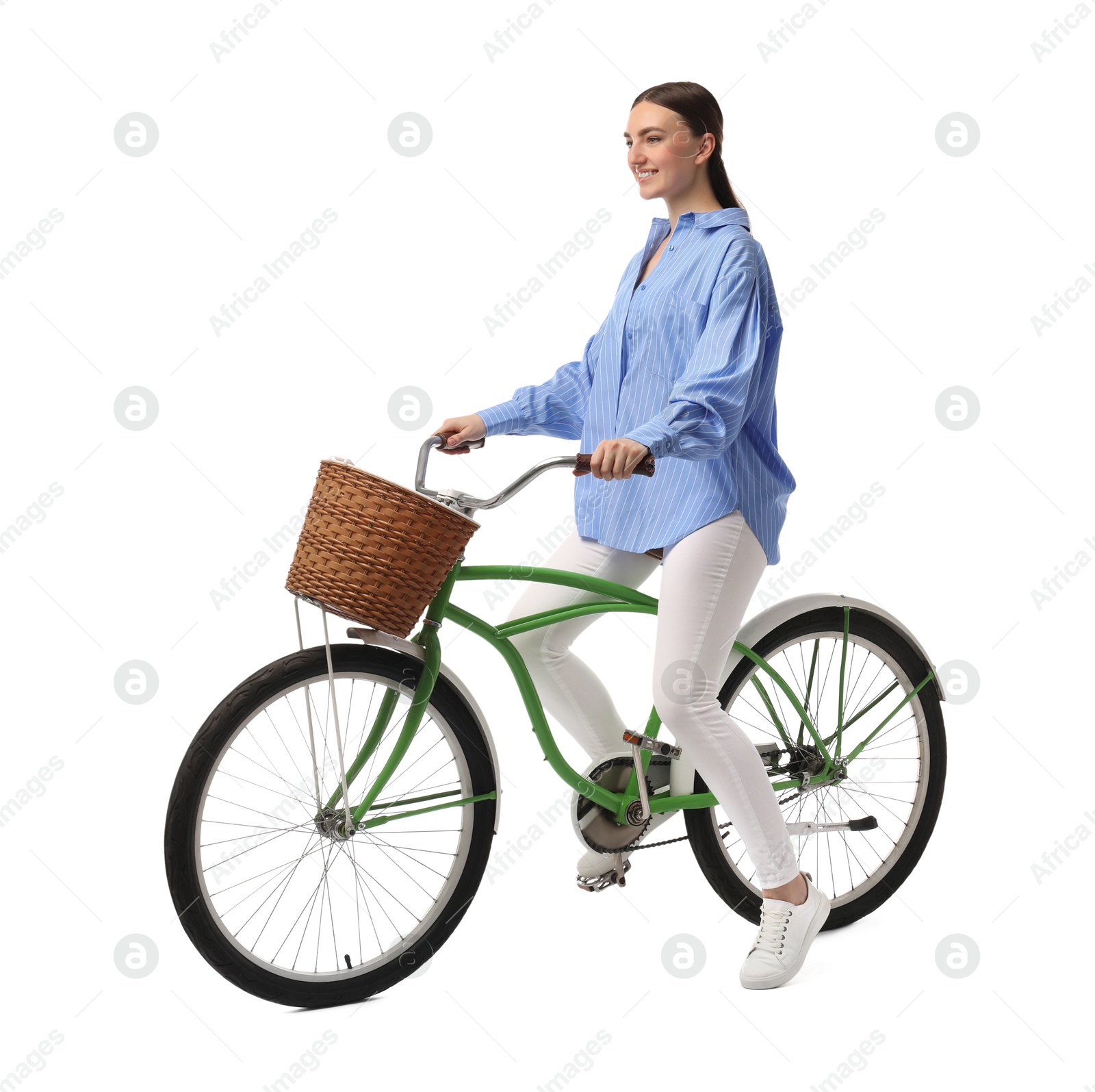 Photo of Smiling woman on bicycle with basket against white background