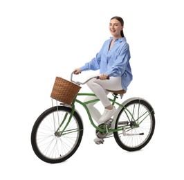 Smiling woman riding bicycle with basket isolated on white