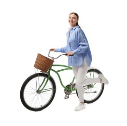 Smiling woman with bicycle and basket isolated on white